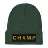 The Bold & brave CHAMP Embroidered Beanie is a green knit accessory featuring a folded brim and a black patch with CHAMP embroidered in bold yellow letters.