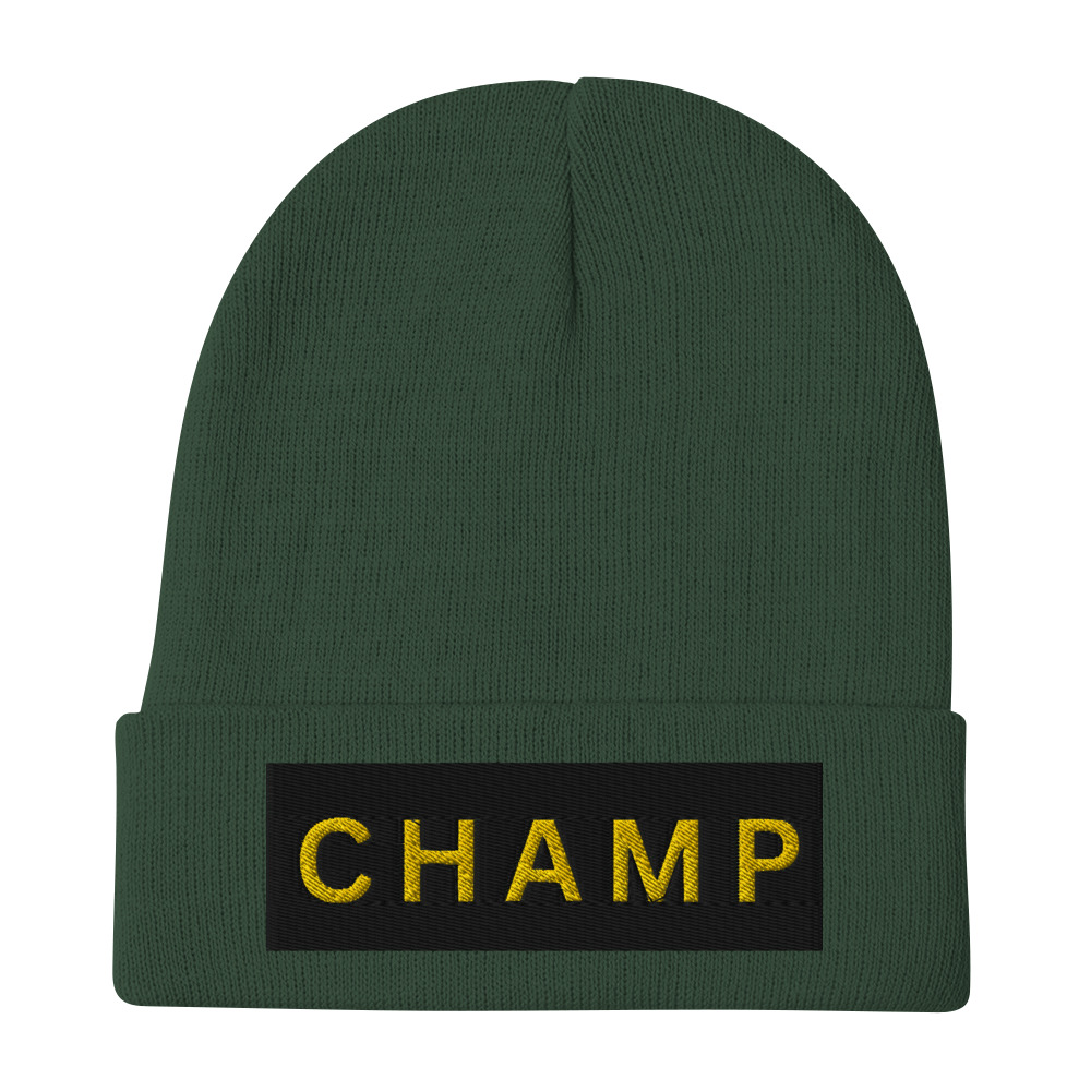 The Bold & brave CHAMP Embroidered Beanie is a green knit accessory featuring a folded brim and a black patch with CHAMP embroidered in bold yellow letters.