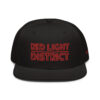 The RED LIGHT DISTRICT snapback cap, in sleek black, features Red Light District embroidered in bold red letters and is designed with a stylish grey under visor.