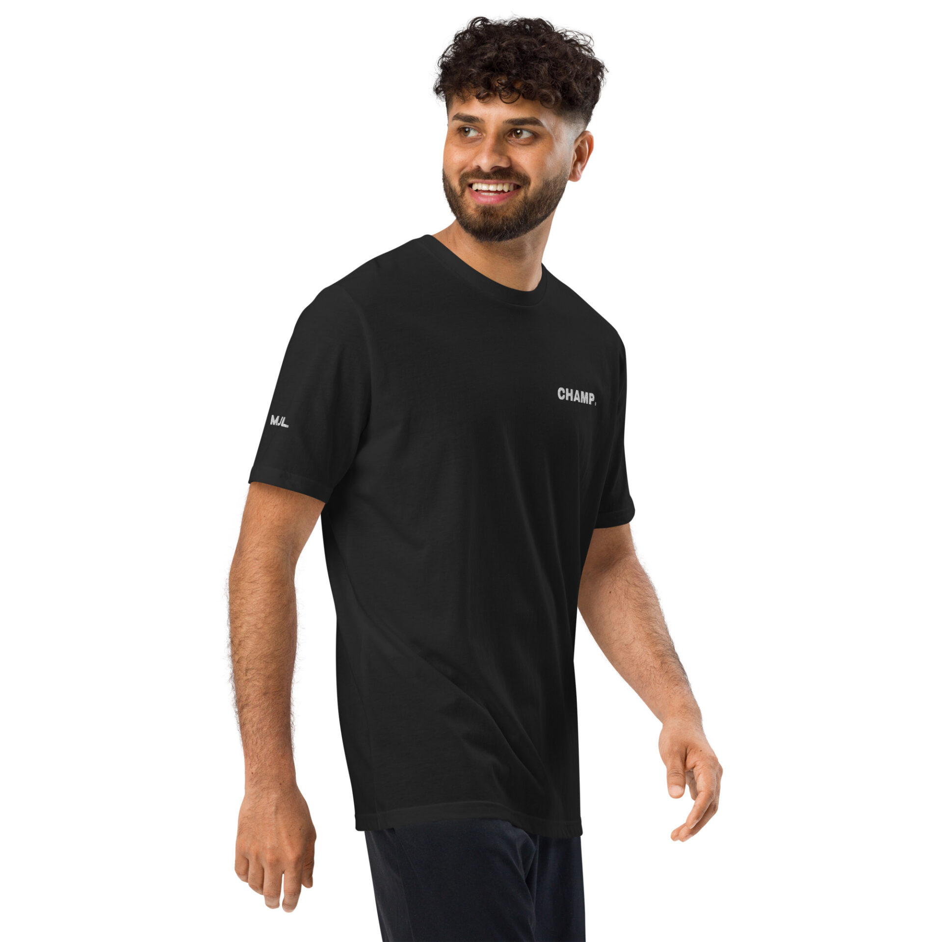 A man with curly hair and a beard is smiling as he walks, wearing the Under ArmourⓇ athletic t-shirt CHAMP featuring CHAMP. on the chest. The background is plain white. A man with curly hair and a beard is smiling as he walks, wearing the Under ArmourⓇ athletic t-shirt CHAMP featuring CHAMP. on the chest. The background is plain white.