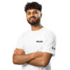 A curly-haired, bearded man smiles with his arms crossed, wearing a white Under ArmourⓇ athletic t-shirt with BAAS. on the chest and the brands logo on the sleeve, standing against a white background. A curly-haired, bearded man smiles with his arms crossed, wearing a white Under ArmourⓇ athletic t-shirt with BAAS. on the chest and the brands logo on the sleeve, standing against a white background.